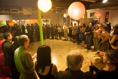 A group of people standing in a circle and praying