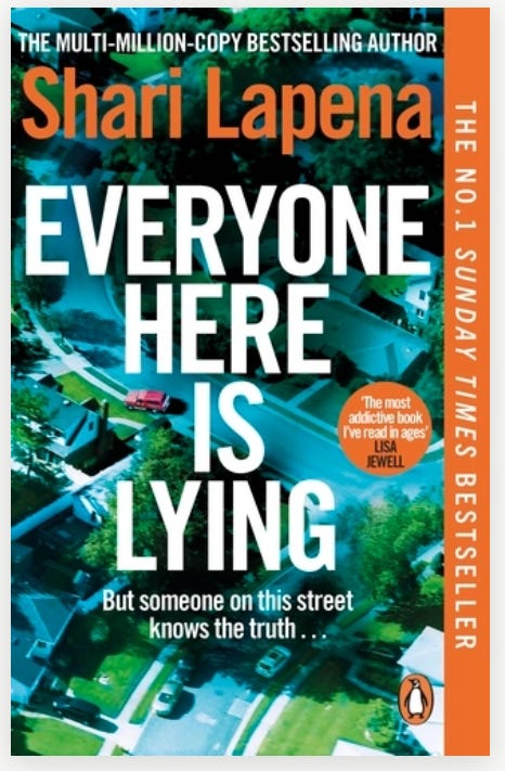 The book cover for Everyone Here Is Lying by Shari Lapena. The title is in very large white, block letters, dominating the center of the image. The author's name, Shari Lapena, is in orange letters near the top. The background is a slightly blurred, high-angle photograph of a suburban neighborhood street with green lawns and white houses, tinted with a dramatic teal or cool green filter. The cover also features the taglines, "The multi-million-copy bestselling author," "THE NO. 1 SUNDAY TIMES BESTSELLER," and "But someone on this street knows the truth..." A small orange circle near the center contains a quote from Lisa Jewell: "The most addictive book I've read in ages."