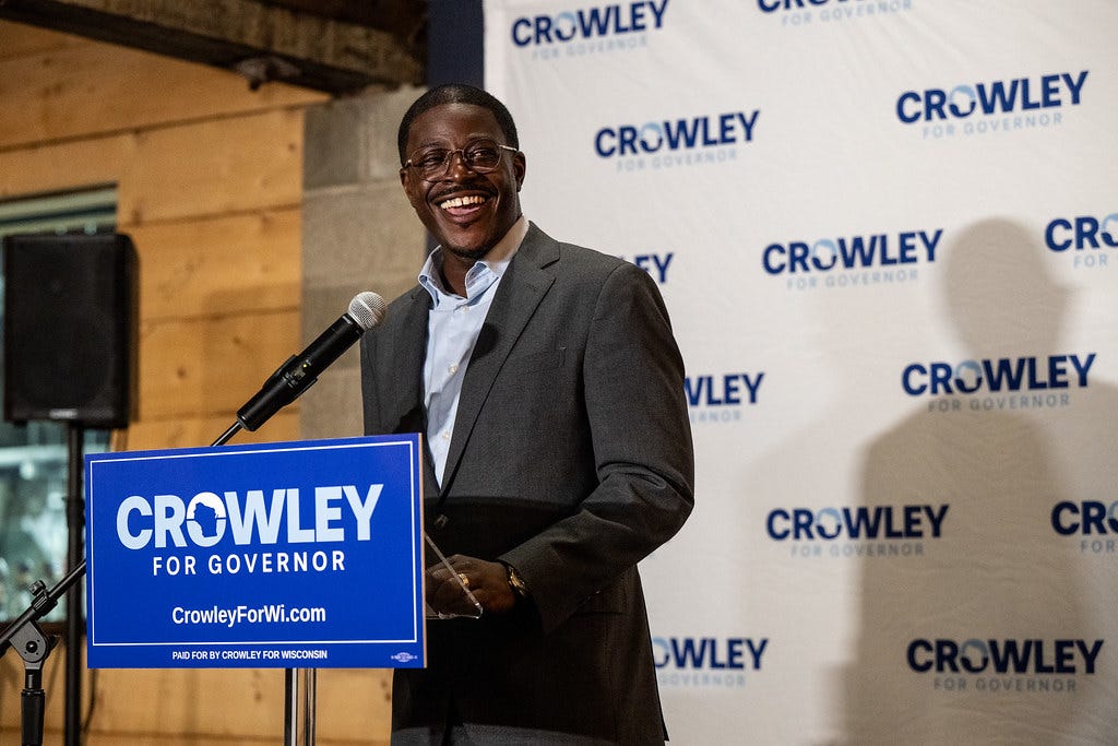 David Crowley smiling at a podium