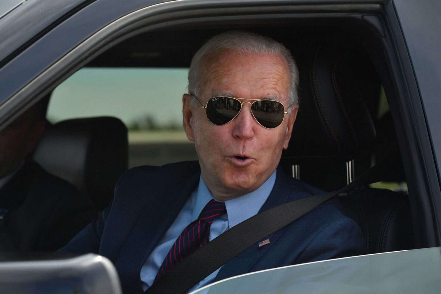 President Joe Biden talks to the media after driving the new electric Ford F-150 Lightning in Dearborn, Mich. 