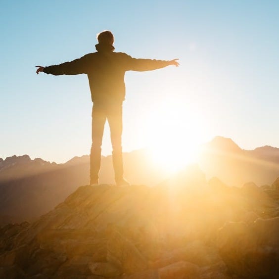 person standing on hill