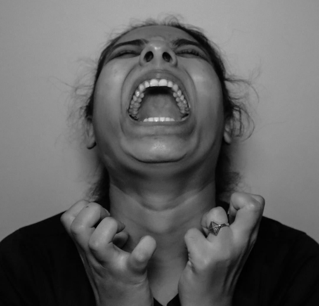 a woman with her mouth open and hands in front of her face a woman with her mouth open and hands in front of her face