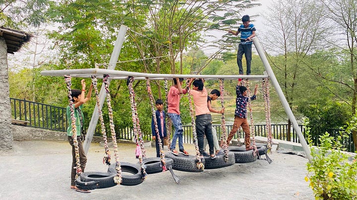 Children playing on swings at Udaan Park, Udaipur, Rajasthan