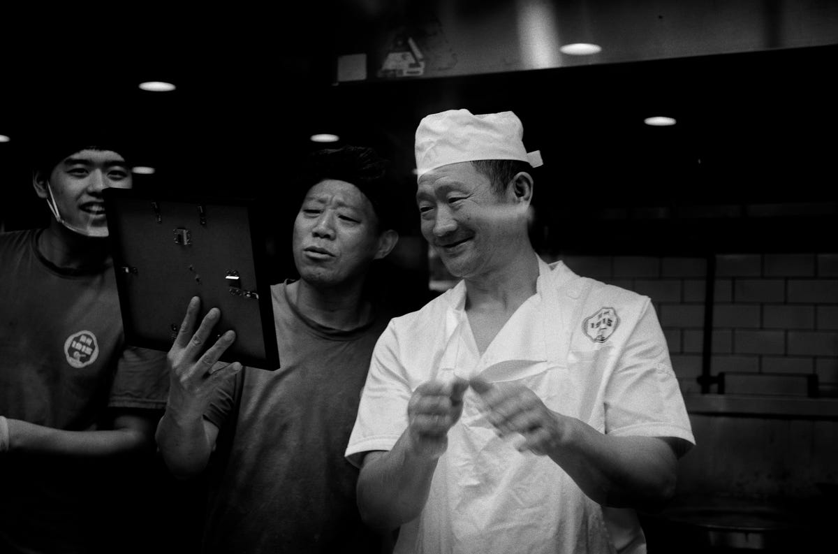 Chefs looking to my printed and framed picture.