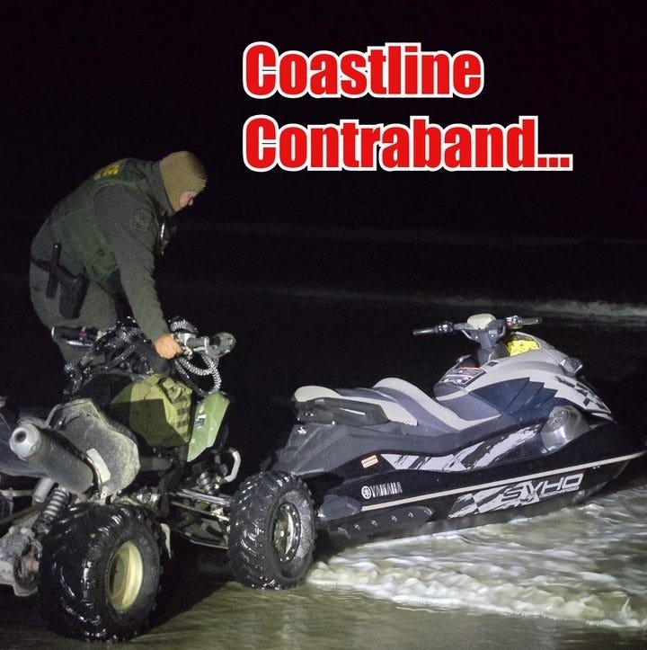 A US Border Patrol Agent secures a personal watercraft used in a human smuggling attempt on a San Diego beach 