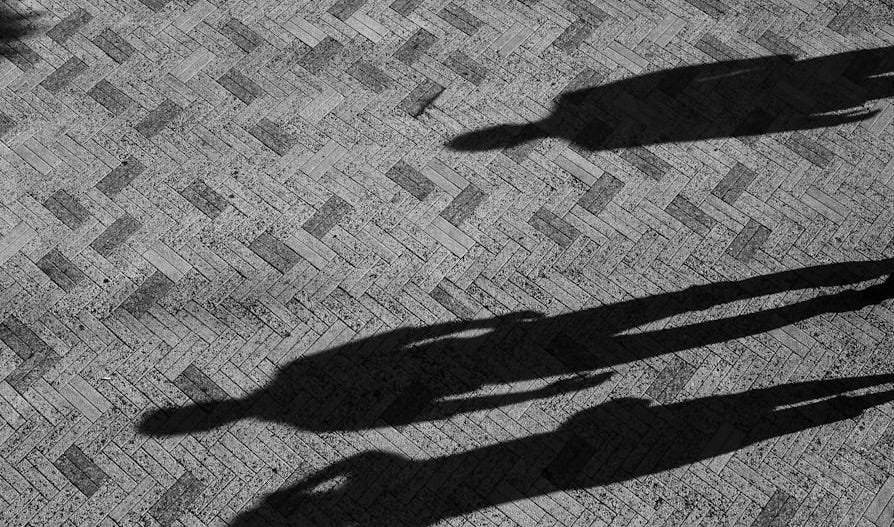 two people standing on concrete floor