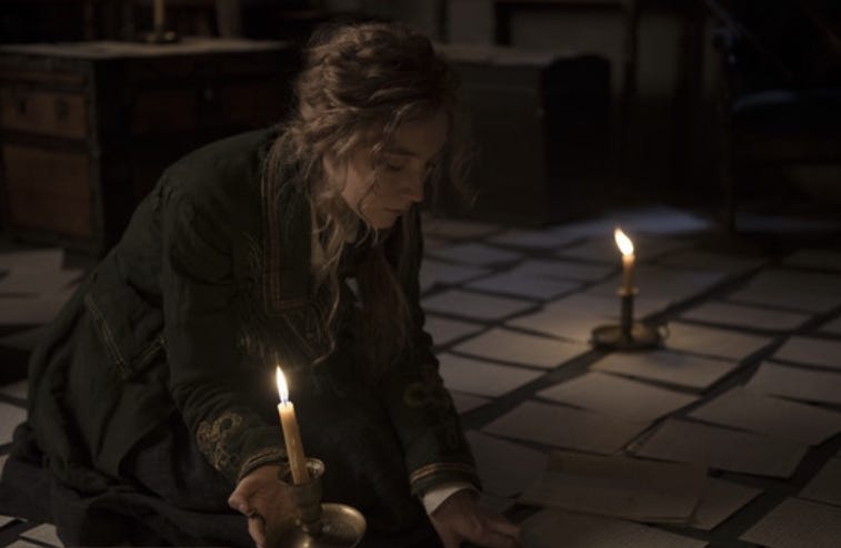 Jo March in Little Women surrounded by manuscript pages on the floor, and candles Jo March in Little Women surrounded by manuscript pages on the floor, and candles