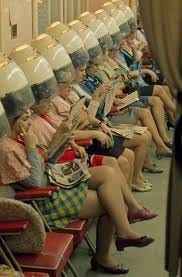 Ladies under the dryers in a hair salon ...
