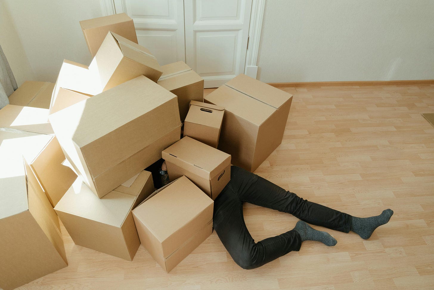 A person collapsed under too many boxes