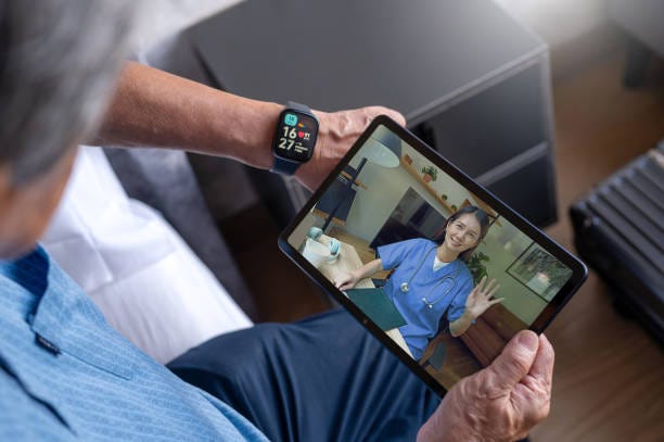 telemedicine at home using digital tablet over shoulder view of Senior patient taking online consultation with doctor through digital tablet at home Telemedicine  stock pictures, royalty-free photos & images