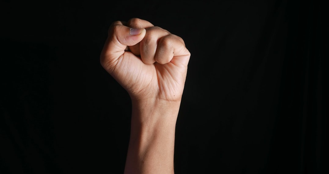 persons right hand doing fist gesture