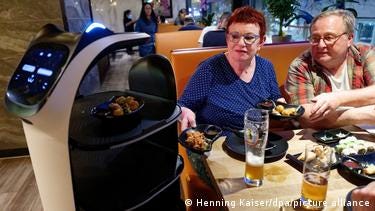 A robot waits on patrons at Cologne's Nakoyashi sushi restaurant. A robot waits on patrons at Cologne's Nakoyashi sushi restaurant.