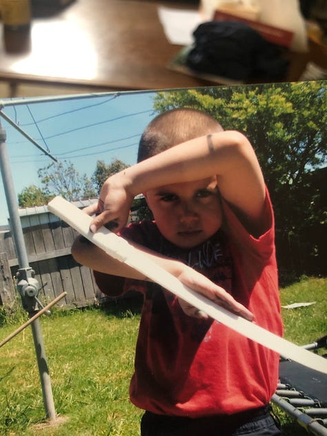 Gaden aged 8 plays with swords. They are very serious and concentrated.