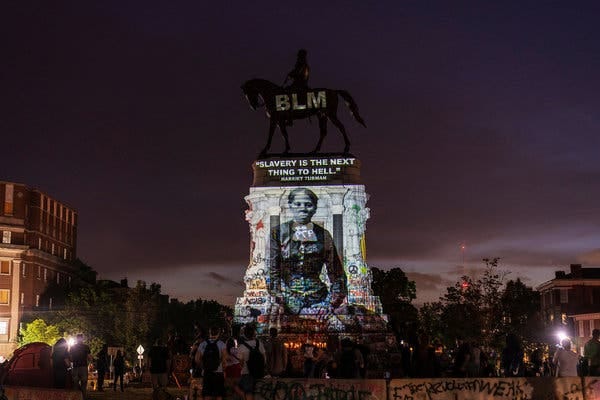 Harriet Tubman projected on statue of Lee