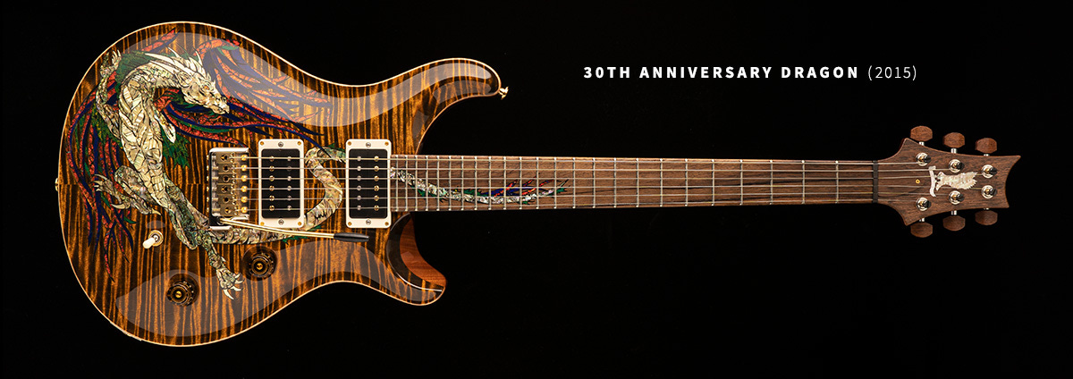 A Paul Reed Smith double humbucker guitar with Dragon on the body and tail running up the neck with One-piece mahogany set-neck, Madagascar rosewood fingerboard with Dragon tail inlay 24 frets; Madagascar headstock veneer with green ripple Private Stock eagle headstock inlay, locking tuners with Madagascar tuner buttons Solid african ribbon mahogany body, Private Stock grade curly maple top with retro carve