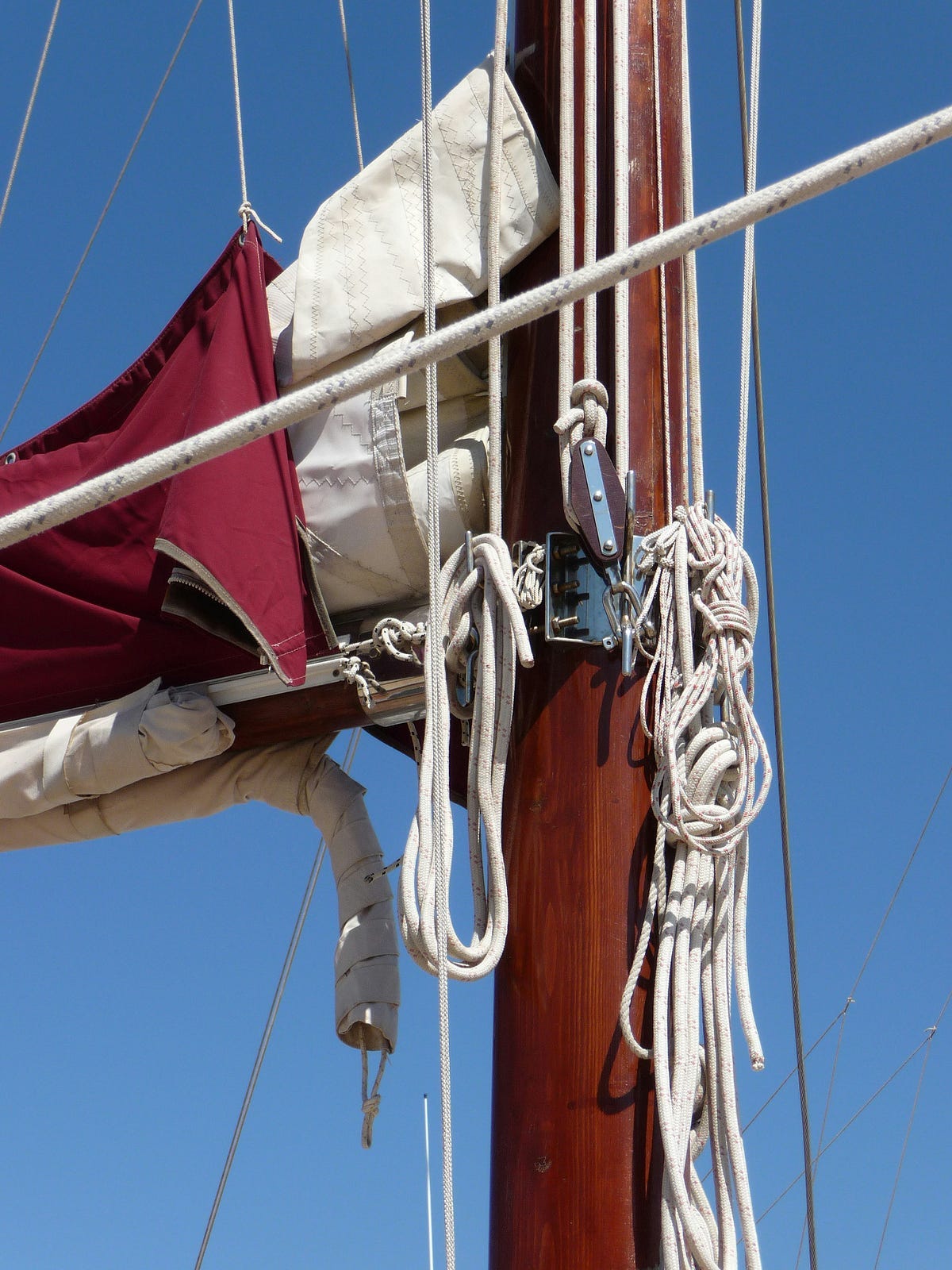 canvas sails tied by ropes to the mast of a ship canvas sails tied by ropes to the mast of a ship
