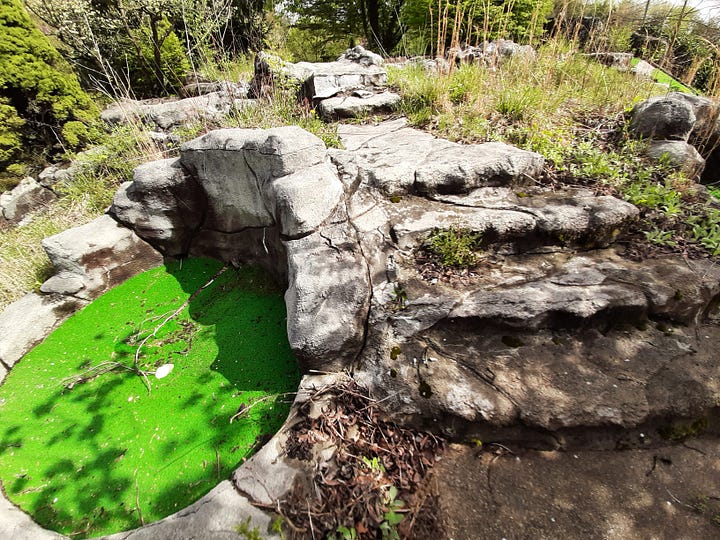 Four pictures showing the old steps at the miniature golf course in Gettysburg that are overgrown with vines.