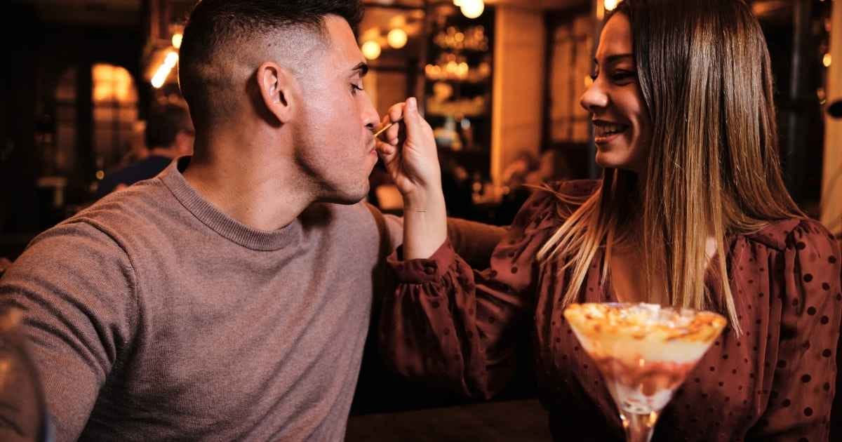 couple sharing and eating a desert together