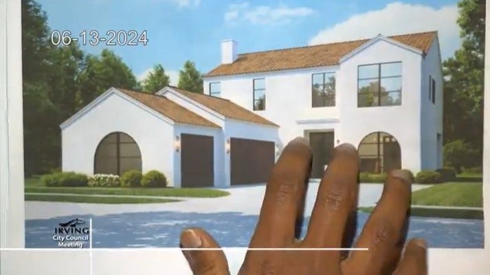 A hand on top of a rendering of a two-story home with a J-swing garage A hand on top of a rendering of a two-story home with a J-swing garage