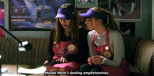 Blair sitting on a couch with Sterling, opening a laptop and saying "Maybe Mom's dealing amphetamines."