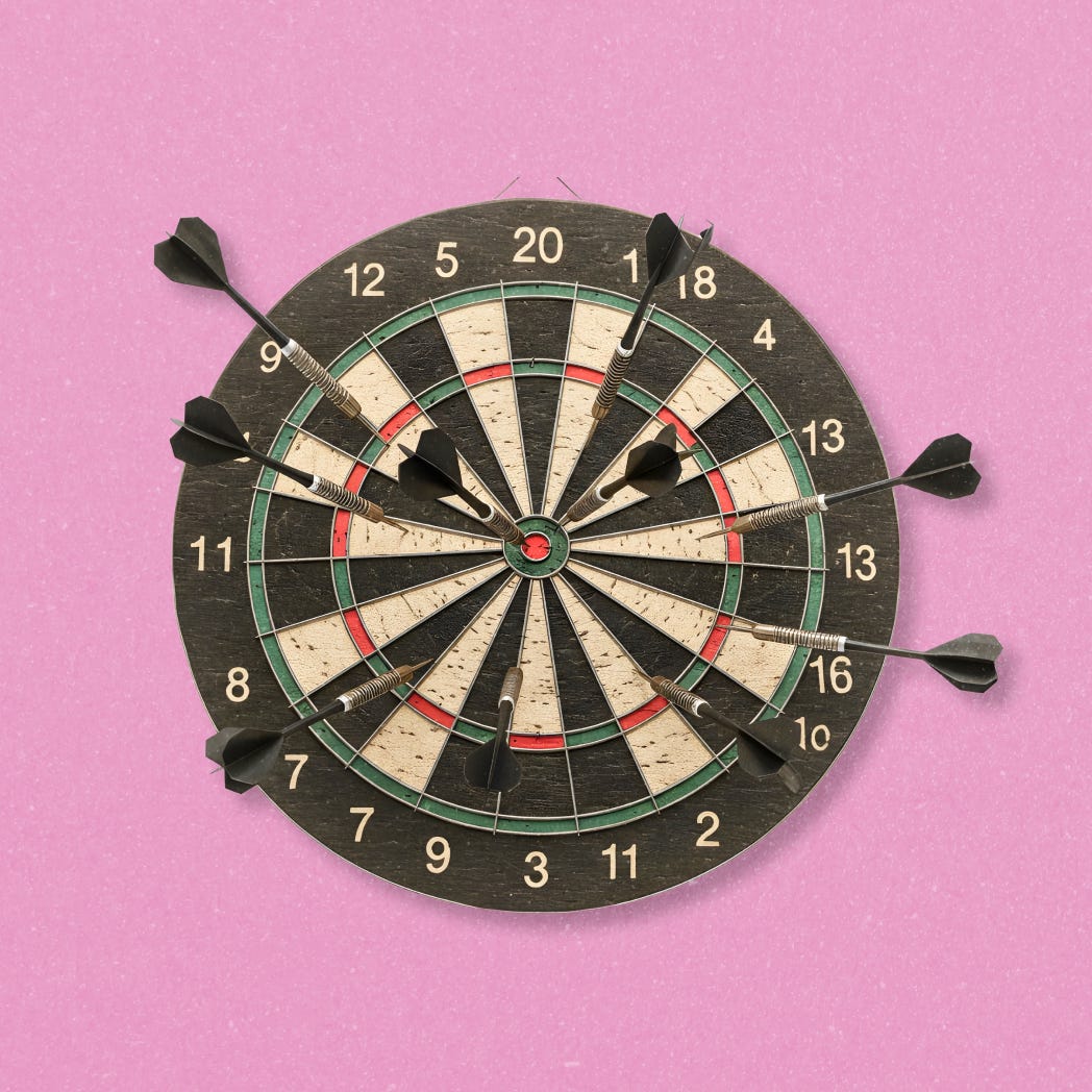 A dart board with darts on it, including one in the center target