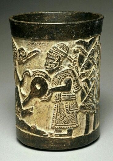 This may contain: a cup with an image of people and animals on the side, in silver color