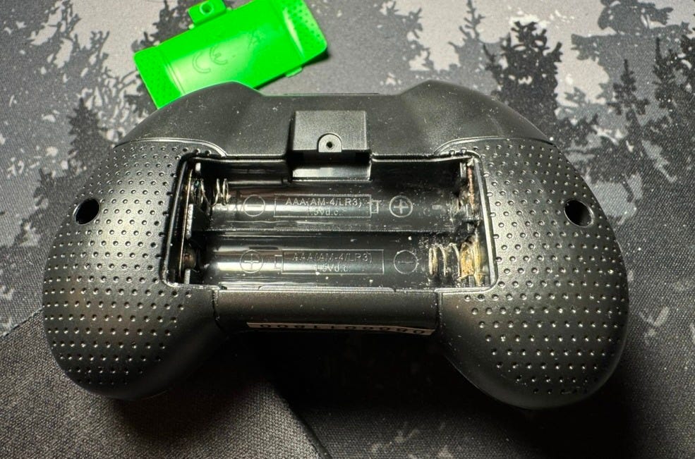 Controller, battery compartment open, showing corrosion internally