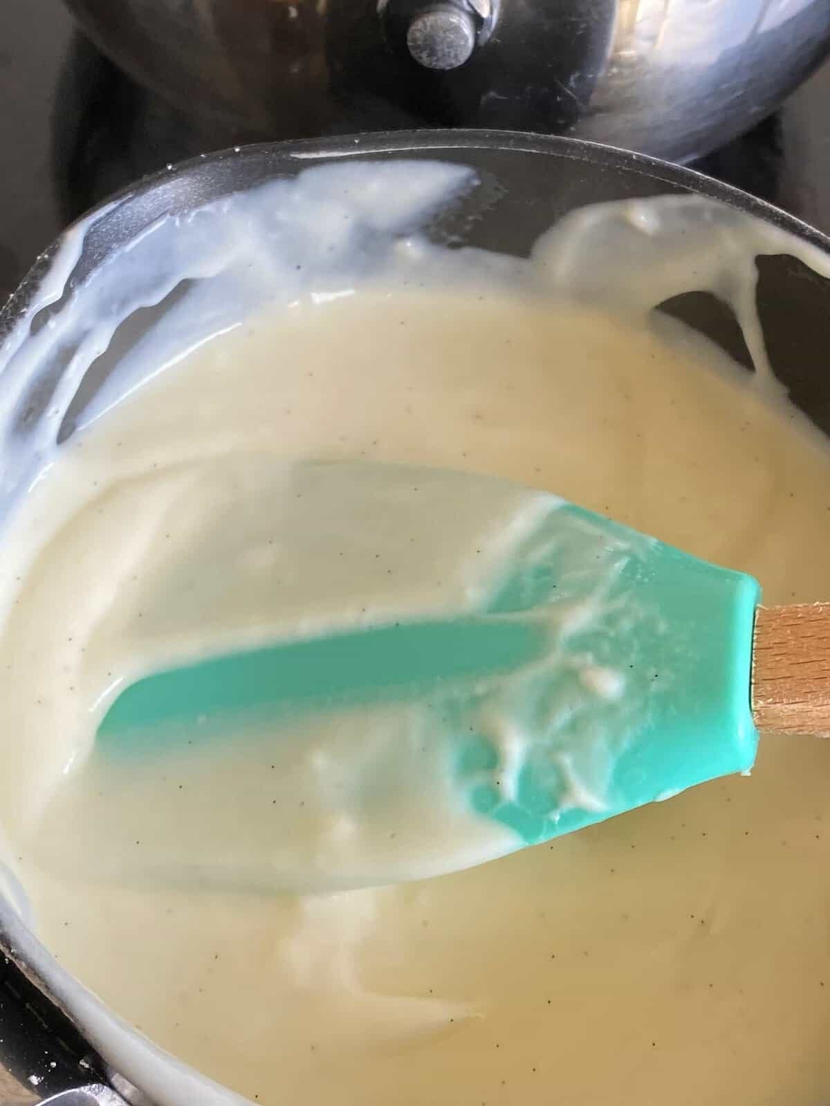 Stirring custard in a pan. Stirring custard in a pan.