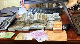 Large sums in cash seized during an anti-corruption raid in western Ukraine targeting senior police officials suspected of taking bribes.