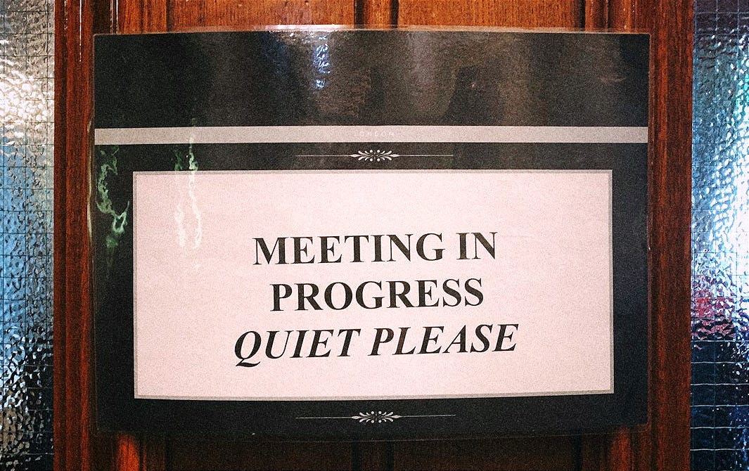 meeting in progress quiet please signage