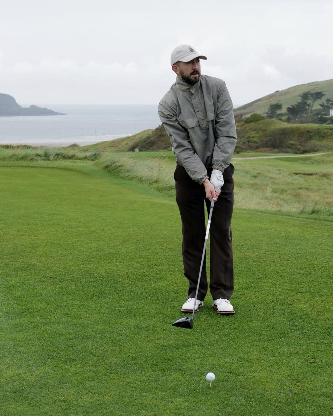 A person playing golf on a golf course

Description automatically generated