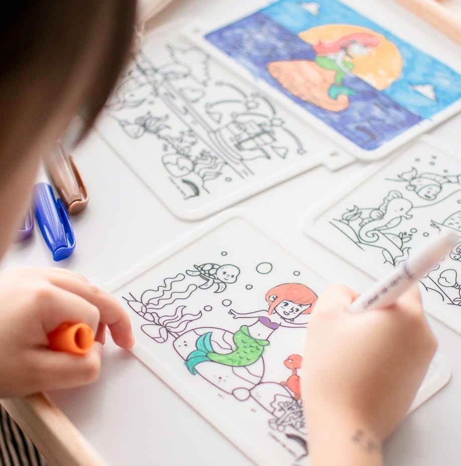 person drawing on white paper
