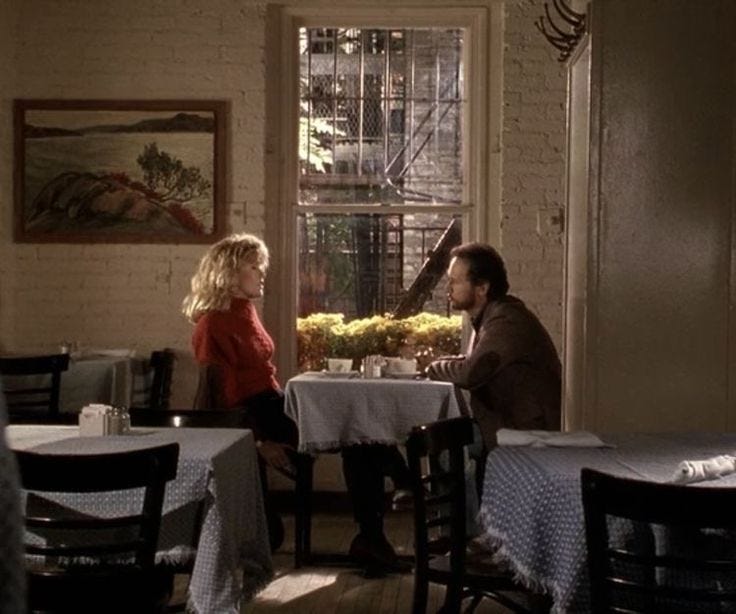 This may contain: two people sitting at a table in a restaurant