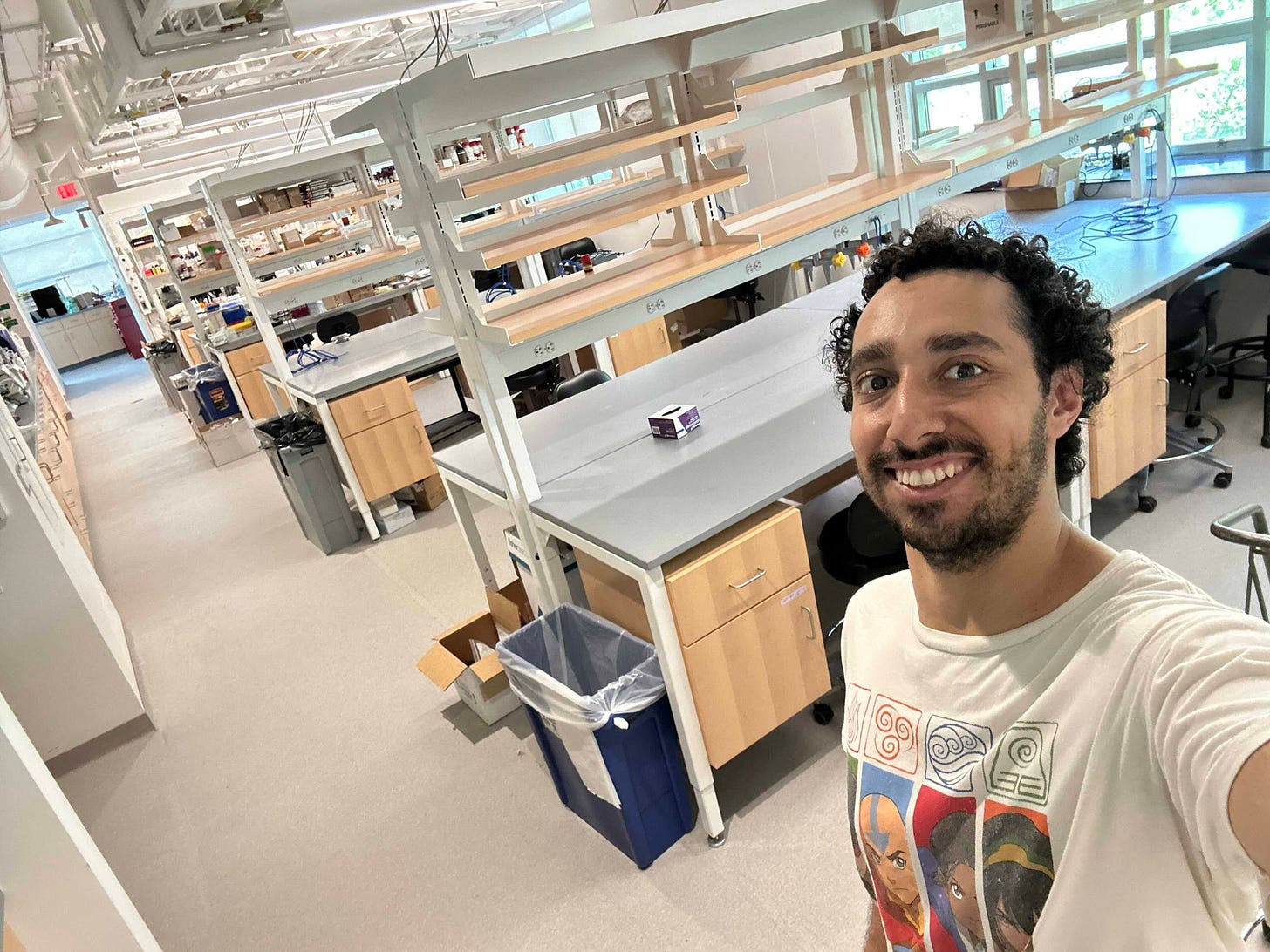 A blank canvas of lab benches and desks awaits in Ithaca! Pablo shows it off (in an Avatar: Legend of Aang t-shirt). A blank canvas of lab benches and desks awaits in Ithaca! Pablo shows it off (in an Avatar: Legend of Aang t-shirt).