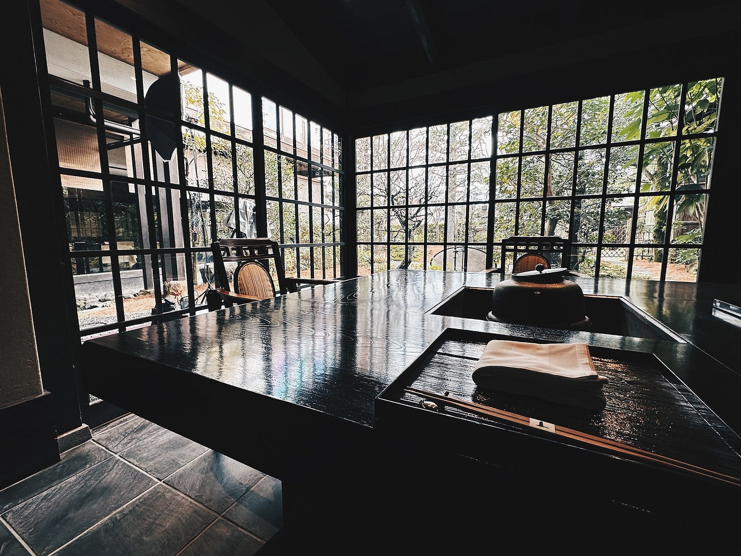 Japanese windows overlooking zen garden at traditional Kyoto kaiseki restaurant Japanese windows overlooking zen garden at traditional Kyoto kaiseki restaurant
