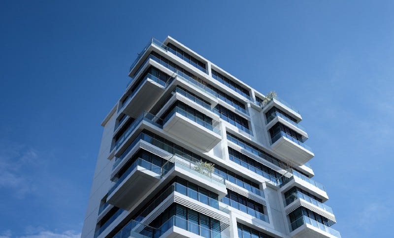 A white condo tower reaching into the sky A white condo tower reaching into the sky