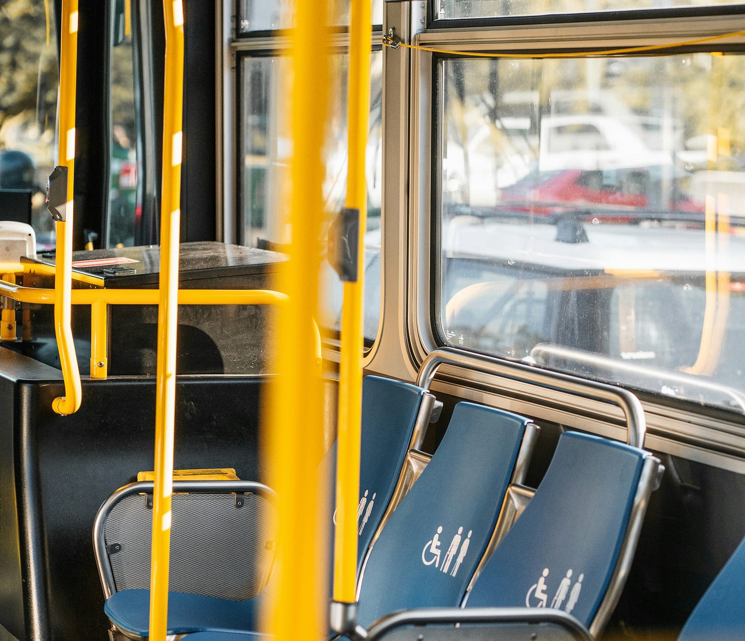 The priority area of a bus, with priority seats marked with disability symbol
