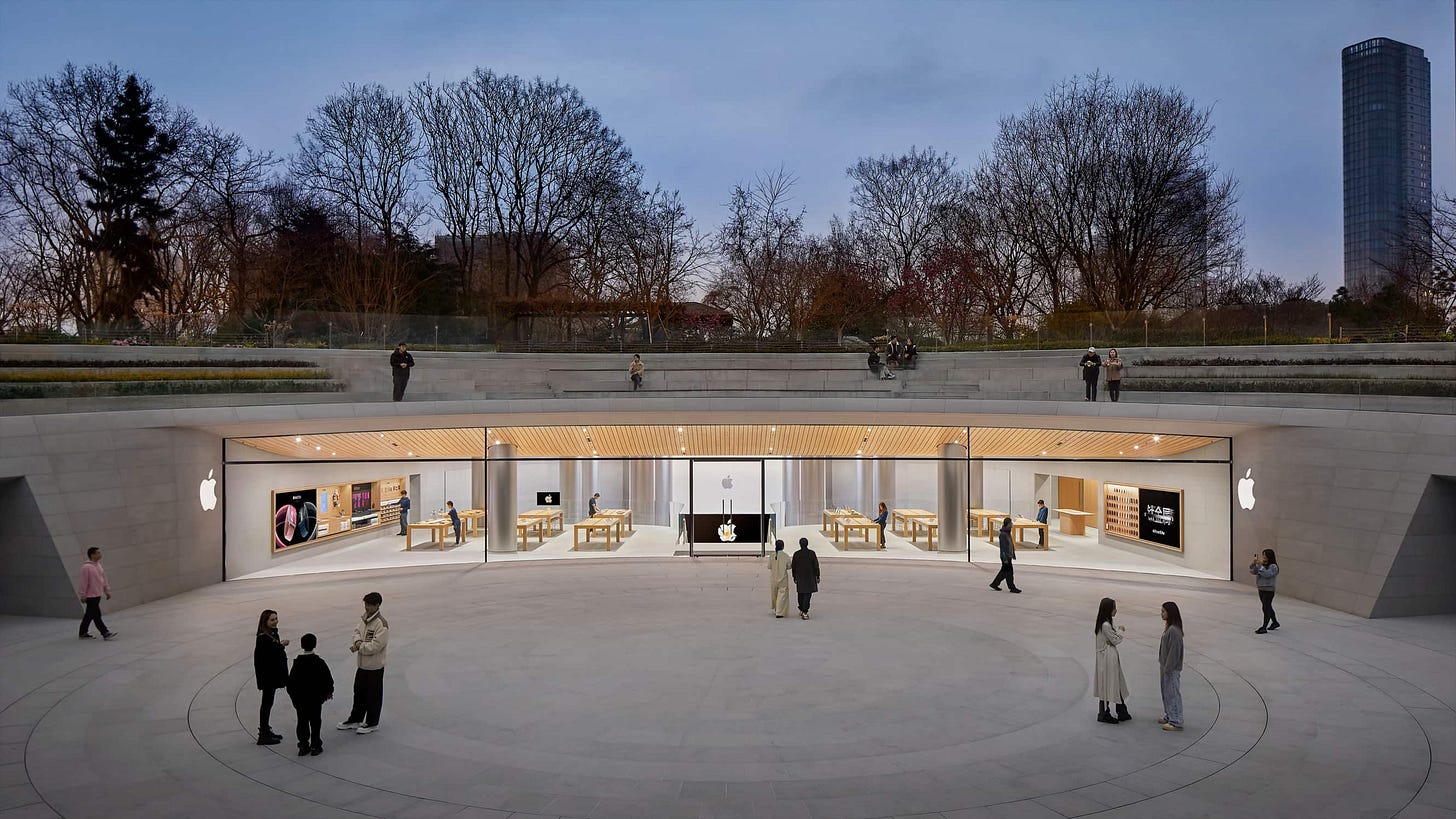 Apple's hero image of Apple Jing'an. The store is pictured at dawn, glowing in soft light.