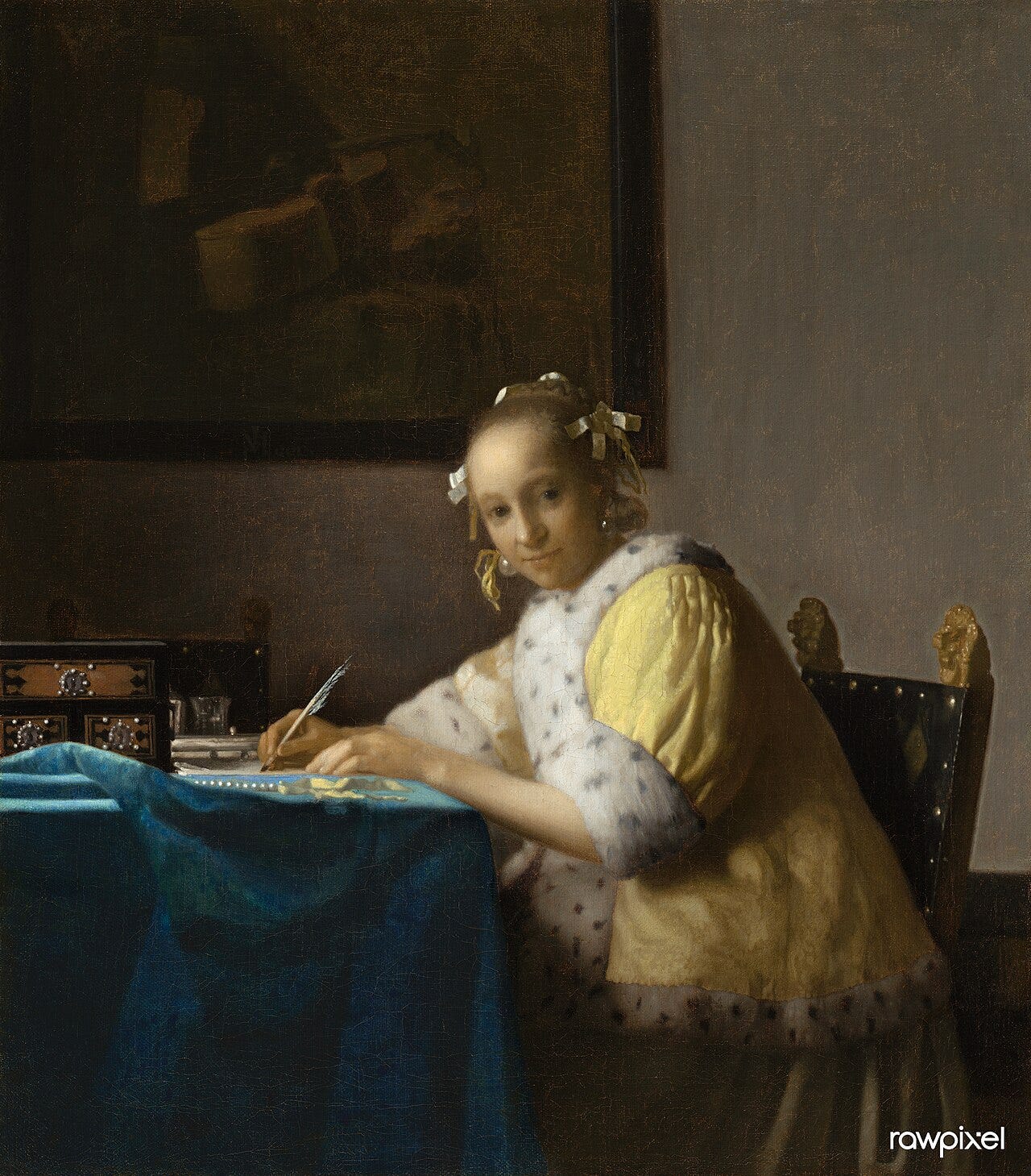 A woman pausing mid letter to look at us A woman pausing mid letter to look at us