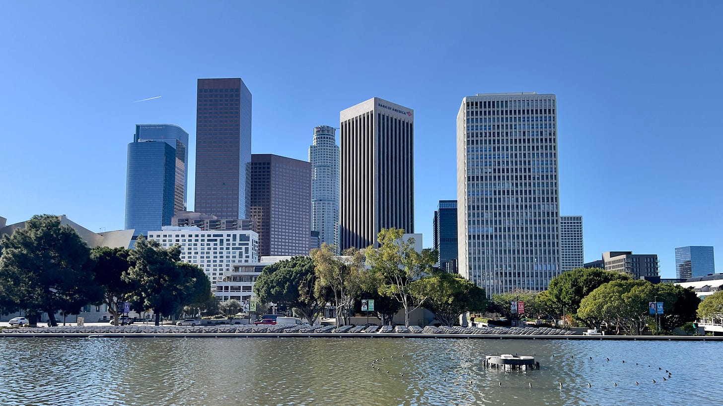 Downtown Los Angeles skyline seen across the reflecting pool at LADWP headquarters on a sunny day. Downtown Los Angeles skyline seen across the reflecting pool at LADWP headquarters on a sunny day.