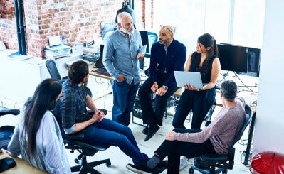 Team of creative people having meeting modern office