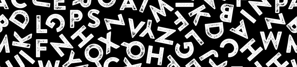 White chalky letters scattered on a black background