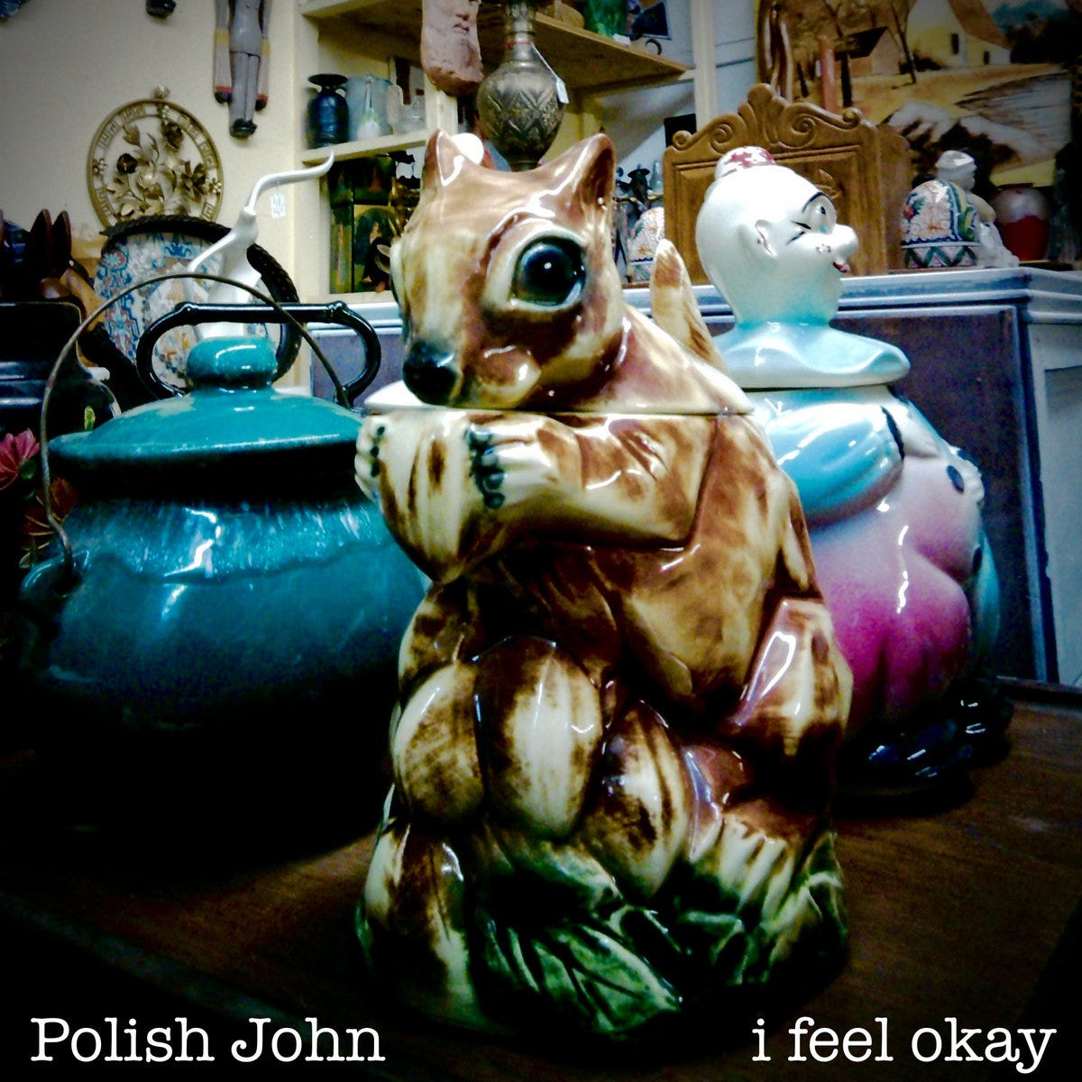 Image of a cookie jar that looks like a squirrel holding a nut on a shelf in an antiques store
