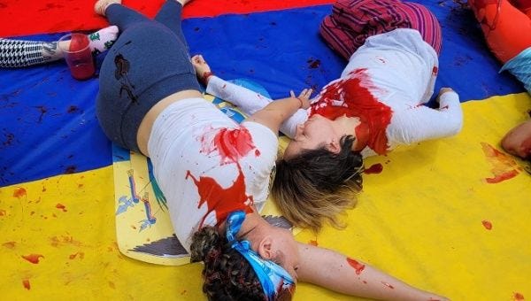 Artists carry out a performance to denounce feminicide in Ecuador, April 2023.