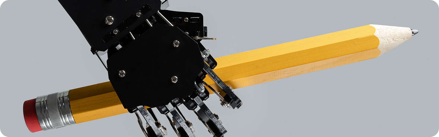 A terrifying robot hand holding... a pencil!