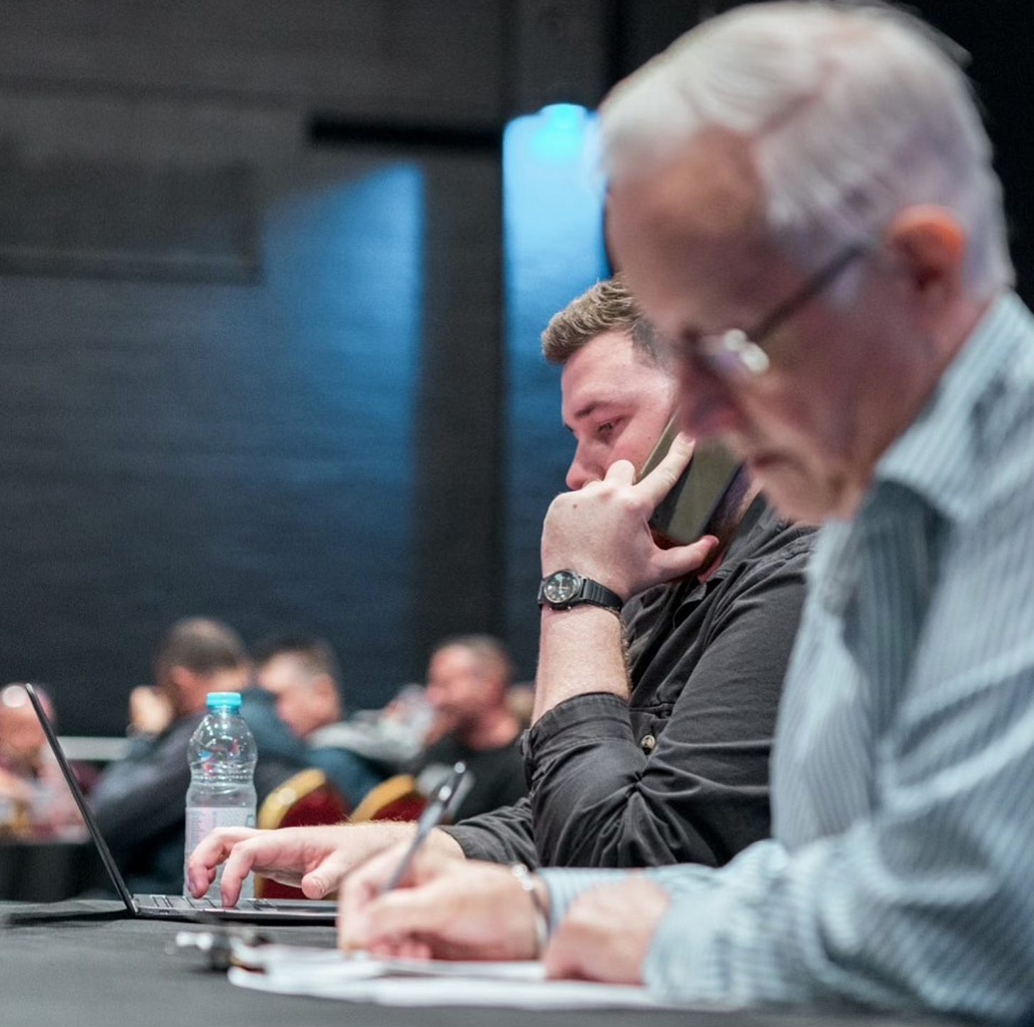 I type on my laptop at ringside, while veteran journalist Gareth Jones pens his notes.