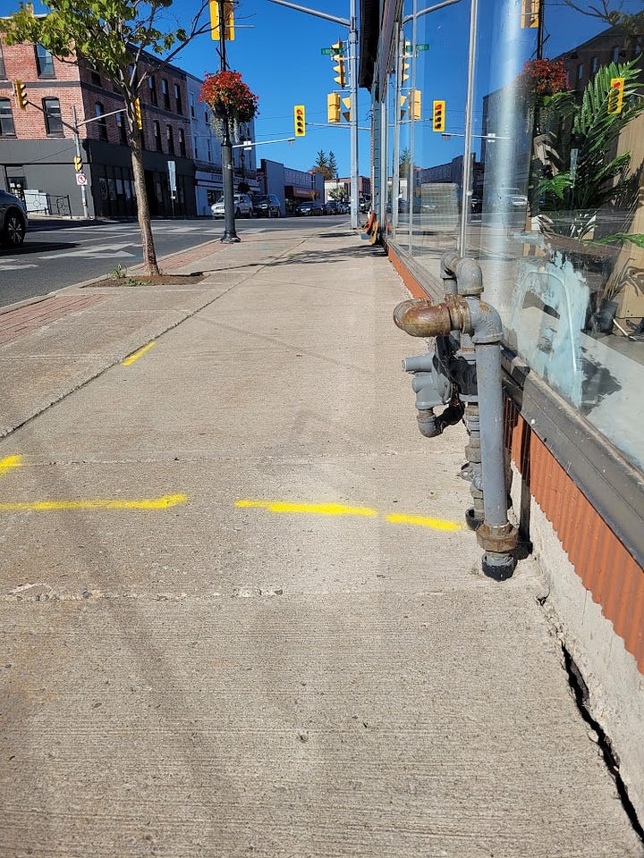 Gas line locations are marked on the sidewalk. 
