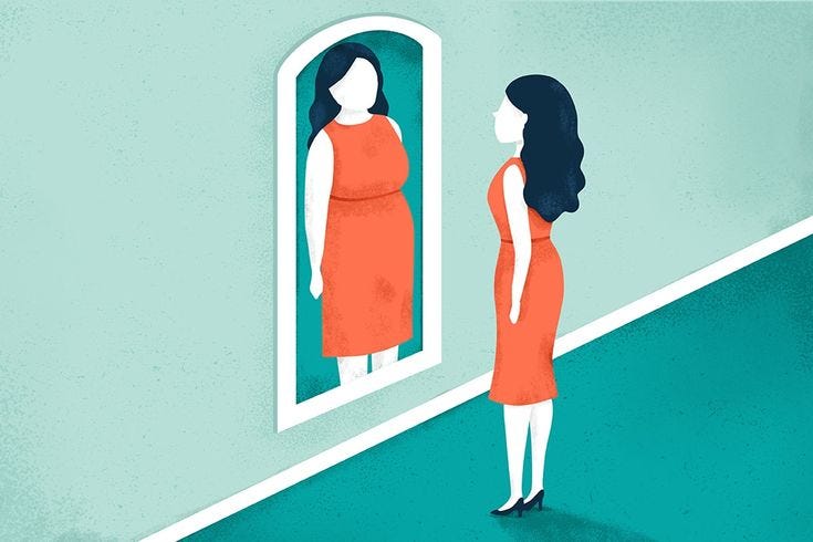 This may contain: a woman standing in front of a mirror looking at herself in the mirror with her reflection This may contain: a woman standing in front of a mirror looking at herself in the mirror with her reflection