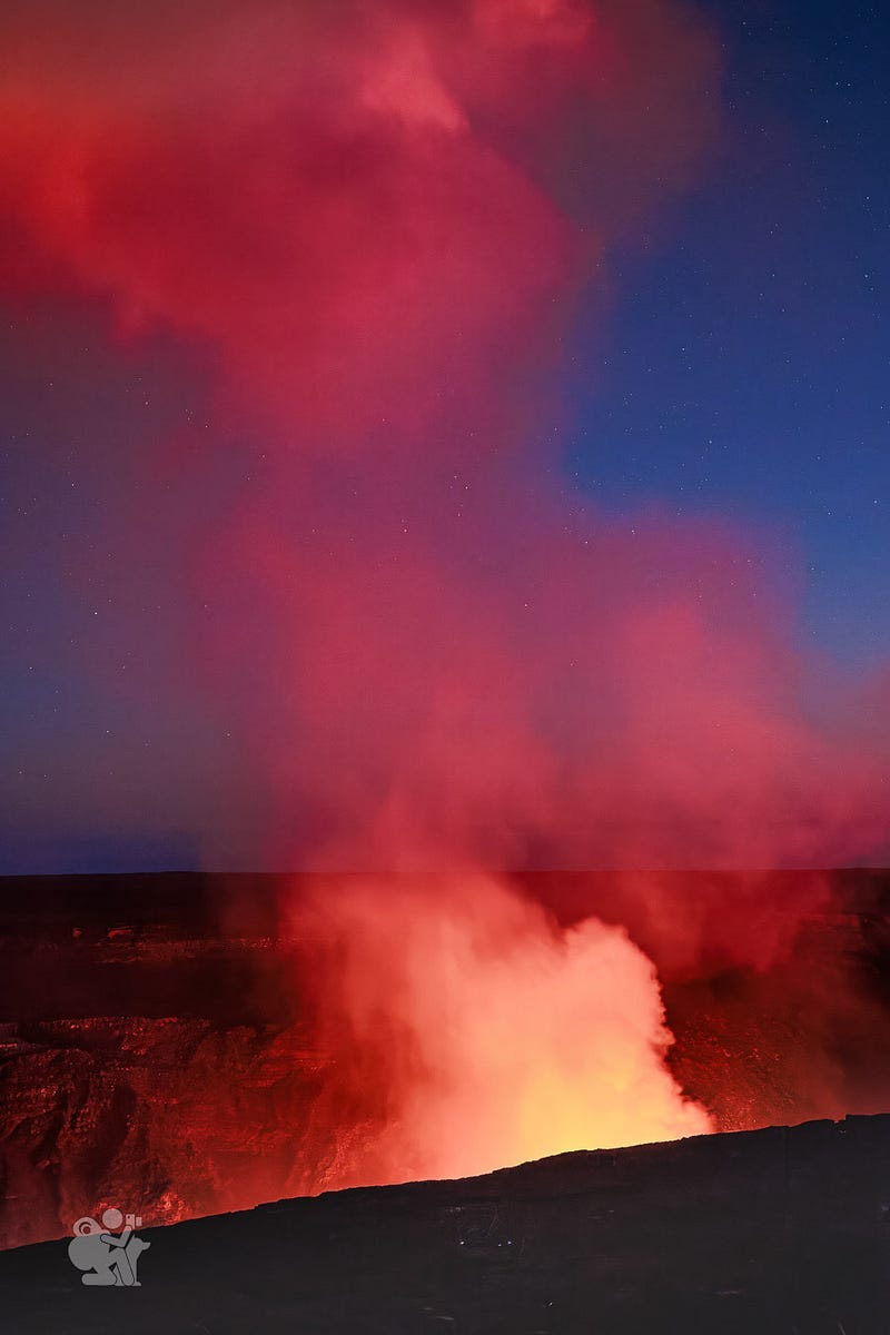 smoke and gas venting from a volcanic crater is illuminated by the molten lava many feet below the edge of the crater smoke and gas venting from a volcanic crater is illuminated by the molten lava many feet below the edge of the crater