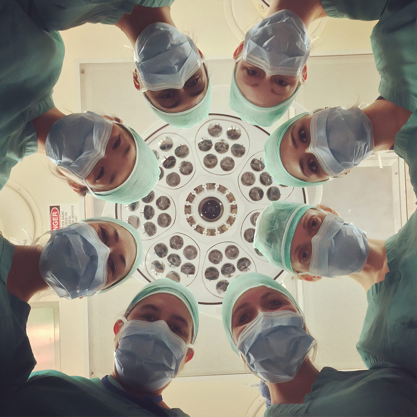 8 doctors staring down at a patient 8 doctors staring down at a patient